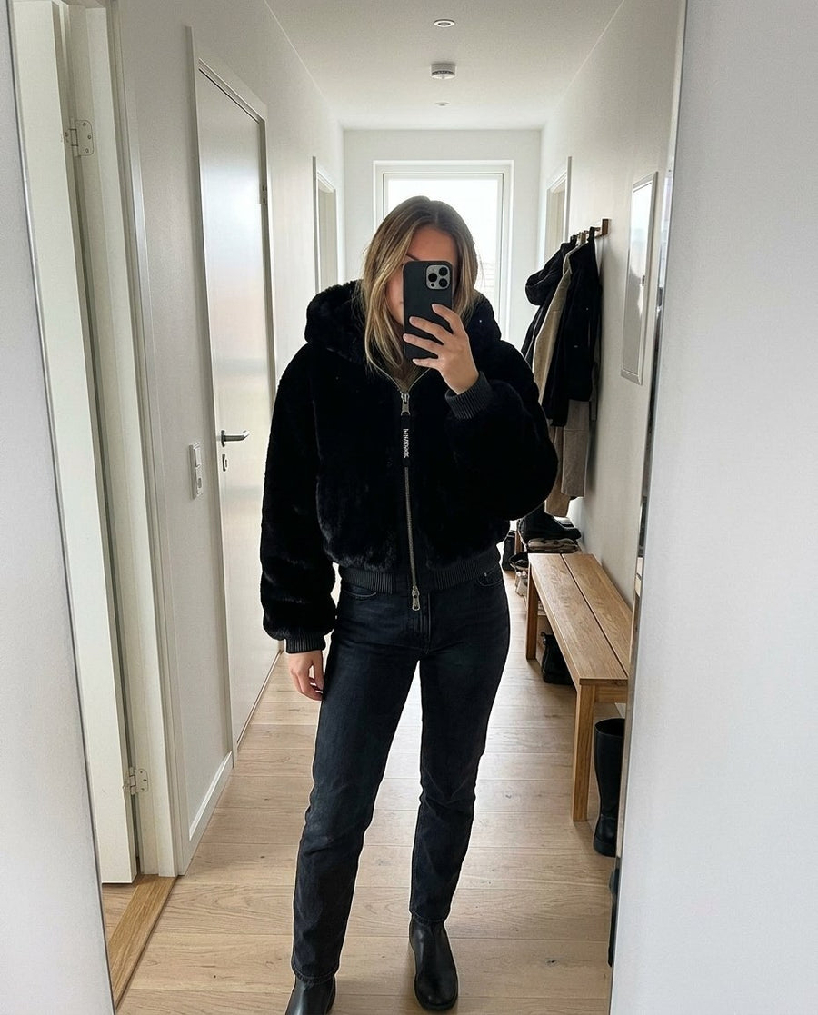 Stina, fuskpälsjacka med huva för dam i svart, stylinginspiration spegelbild i hallen
